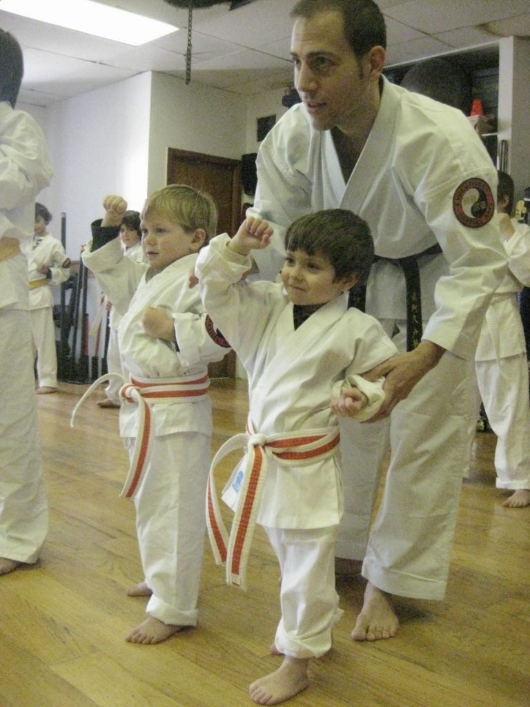 Sensei Tome assisting two younger students